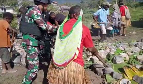 Bakar Batu Warnai Natal Satgas Yonif 143/TWEJ Bersama Masyarakat Papua