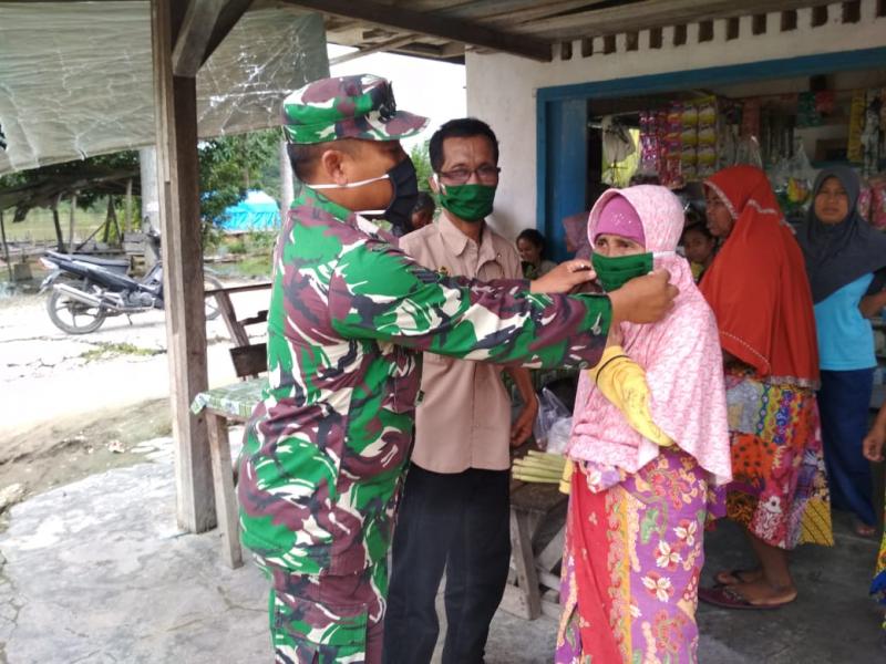 Cegah Covid-19, Babinsa Koramil 05/Kampar Kiri dan Aparatur Desa Bagikan Masker ke Warga