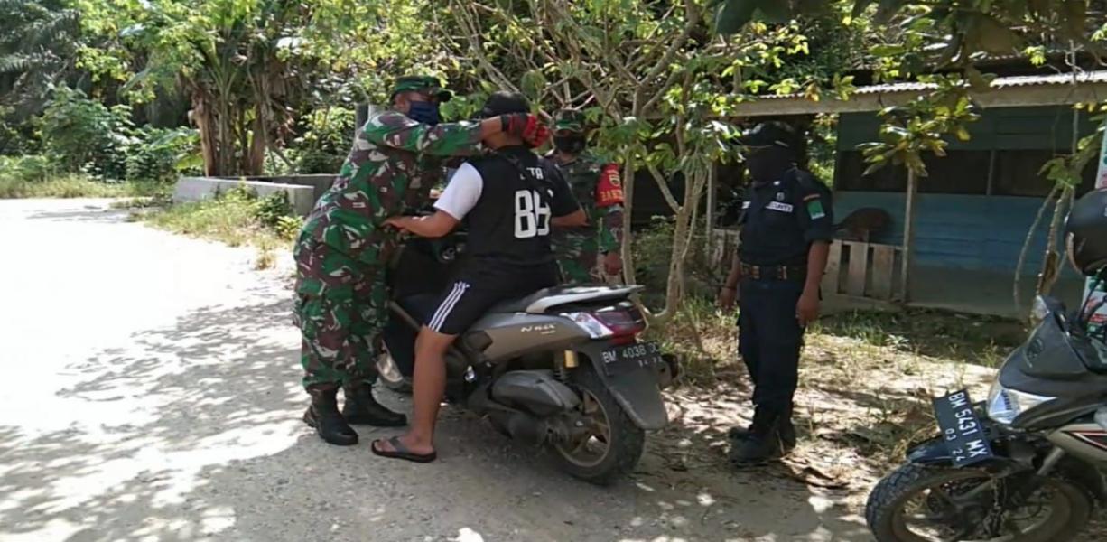 Anggota Koramil 14/Kepenuhan Kodim 0313/KPR Bagikan Masker Untuk Masyarakat